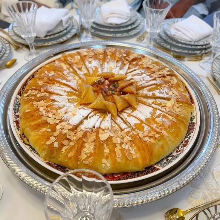 Golden Moroccan chicken bastilla decorated with almonds